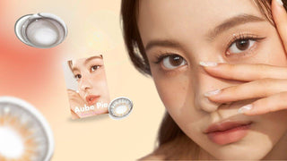 Woman wearing brown circle lenses beside Aube Pie package and contact lenses.