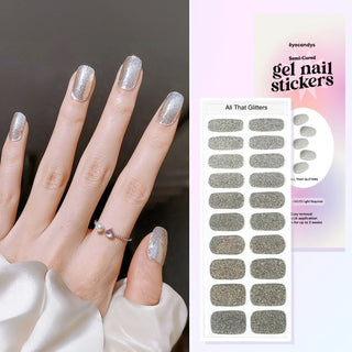 Hand featuring EyeCandys all that glitters gel nail stickers, with a film displaying the design. Ideal for effortless, trendy nail art with durable, vibrant patterns and a professional finish for at-home manicures