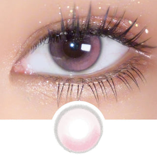 Close-up of an eye with long lashes wearing EyeCandys Amelie Sakura Jelly Pink prescription colored contact lens, showing the lens design below.
