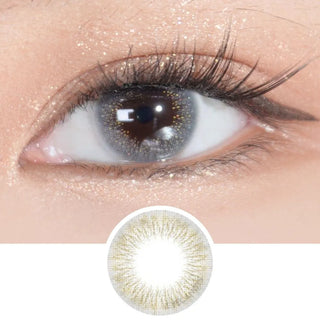 Close-up of an eye with long lashes wearing EyeCandys Attitude Glitter Grey prescription colored contact lens, showing the lens design below.