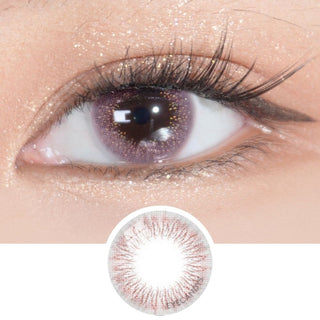 Close-up of an eye with long lashes wearing EyeCandys Attitude Glitter Pink prescription colored contact lens, showing the lens design below.