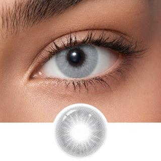A close-up of an eye wearing EyeCandys Aura Olive Grey contact lenses by EyeCandys; below is a detailed image of the lens, showcasing its natural olive grey color pattern and transparency.