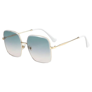 A pair of fashionable EyeCandys Bermuda Oversized Square Sunglasses featuring large, square lenses with a gradient tint fading from blue at the top to clear at the bottom. The gold frame is thin and stylish, complemented by white earpieces.