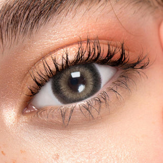 Close up shot of a model with natural dark eyes wearing EyeCandys Pink Label Big Ring Brown colored contact lens complemented by natural eye make up 