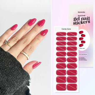 Hand featuring EyeCandys Candy Cane gel nail stickers, with a film displaying the design. Ideal for effortless, trendy nail art with durable, vibrant patterns and a professional finish for at-home manicures