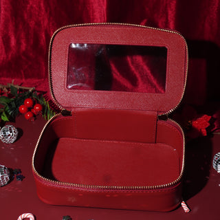 Red EyeCandys Holiday Essentials Case with clear window and gold snowflake hardware, ideal for winter trips and year-end plans.