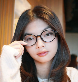 Close-up of model’s face showcasing EyeCandys Chase Round Oval prescription reading glasses with blue light blocking lenses, offering stylish protection and clear vision