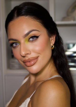 Angled profile view of a female model with naturally dark eyes wearing the EyeCandys Dare to be Grey colored contact lens