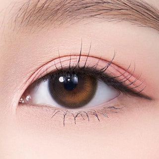 Macro shot of an eye wearing the Olola Daymood Brown (KR) prescription colour contact lens, showing the multi-colored detail and natural effect on dark brown eyes.