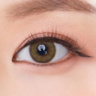 Macro shot of an eye wearing the Olola Dearsome Olive Green (KR) prescription colour contact lens, showing the multi-colored detail and natural effect on dark brown eyes.