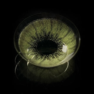 EyeCandys Desire Lush Green contact lens presented in a glass bowl against a dark backdrop
