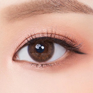 Macro shot of an eye wearing the Olola Dewie Brown (KR) prescription colour contact lens, showing the multi-colored detail and natural effect on dark brown eyes.