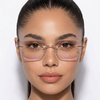 Model wearing EyeCandys Dusk Rimless Glasses with Blush Peach tint, stylish rimless frames with a soft peach blush tint for a modern everyday look.