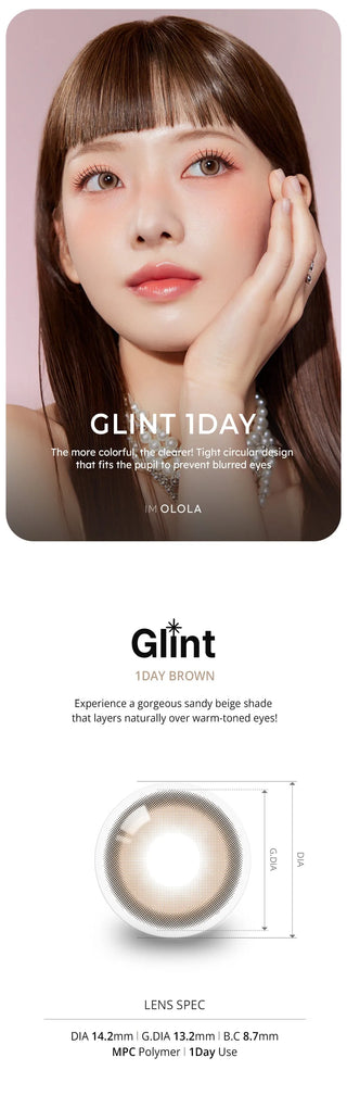 A woman with straight brown hair poses with her hand on her cheek, wearing Olola Glint 1-Day Grey (10pk) by Olola. Below is a close-up of the grey lenses and their specs for diameter and base curve.