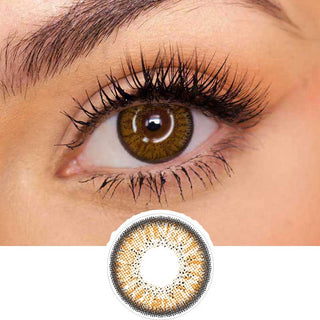 Pink Label Eyelighter Brown color contact lens on top of a dark eye paired with subtle eye makeup and curled wispy eyelashes, above the contact lens design.