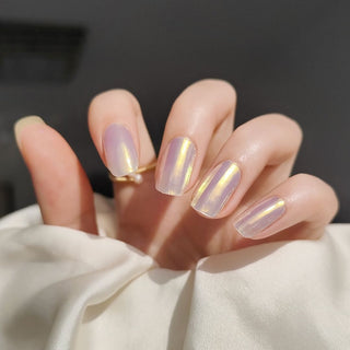 Model's hand showcasing EyeCandys Fiji Girlie Gel Nail Stickers. These iridescent white stickers offer a shimmering, elegant finish, providing a glossy, long-lasting manicure with minimal effort. The soft, radiant hue adds a touch of sophistication and style to any look