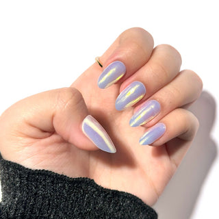 Model's hand showcasing EyeCandys Fiji Gel Nail Stickers. These iridescent white stickers offer a shimmering, elegant finish, providing a glossy, long-lasting manicure with minimal effort. The soft, radiant hue adds a touch of sophistication and style to any look