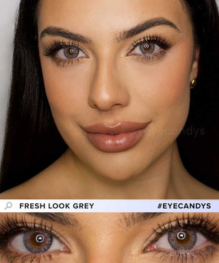 A female model with natural dark eyes wearing Pink Label Fresh Look Grey contact lenses, complemented by subtle eyeshadow and redlipstick and Close-up image showcases the model's eyes adorned with the same grey contact lenses