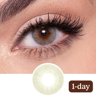 Close-up of eye with long lashes wearing Eyecandys Glossy Ivory 1-Day (10pk) contact lenses, showcasing the lens design and natural brightening effect.