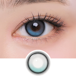 i-Girl One Pick Forest Tea color contact lens on top of a dark eye paired with subtle eye makeup and curled wispy eyelashes, above the contact lens design.