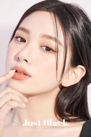 A close-up of a model demonstrating a natural makeup look with Ann365 JUST 1-Day Black (10pk) circle colour contacts, highlighting how well the contact lenses blend with her dark eyes.