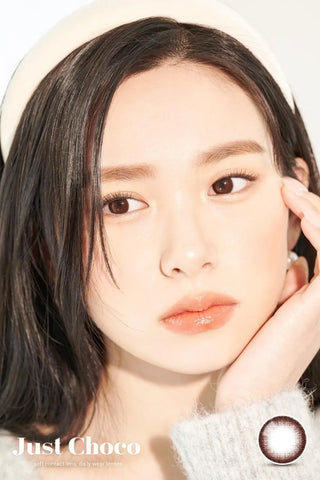 A close-up of a model demonstrating a natural makeup look with Ann365 JUST 1-Day Choco (10pk) circle colour contacts, highlighting how well the contact lenses blend with her dark eyes.