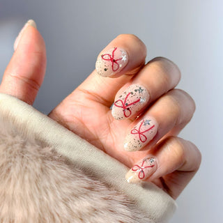 Hands with EyeCandys Knot Yours Gel Nail Stickers, featuring a chic design. Perfect for creating trendy and stylish nails. Ideal for gel nail lovers, easy-to-apply nail stickers for a flawless, long-lasting manicure