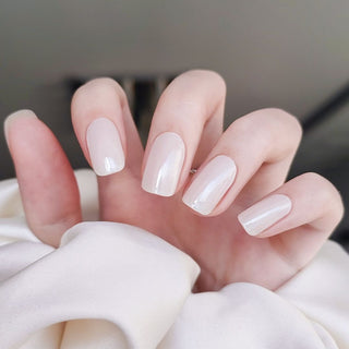 Model's hand showcasing EyeCandys Lychee Gel Nail Stickers. These soft, pinkish stickers offer a delicate, refreshing look with a glossy finish, providing a long-lasting, chip-free manicure that's perfect for adding a subtle, elegant touch to your nails.