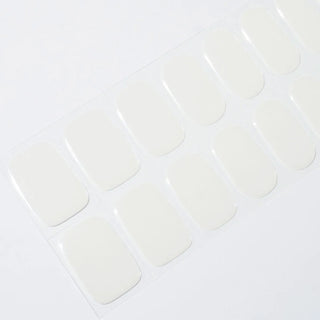 Angled image of semi-cured gel nail stickers in the design 'Lychee,' featuring a classic pearl white base for an elegant classic manicure look.