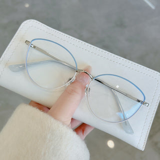 Close-up of EyeCandys Madame stylish prescription glasses in hand, featuring blue light filter, Zeiss HMC anti-reflective coating, and photochromic lens options