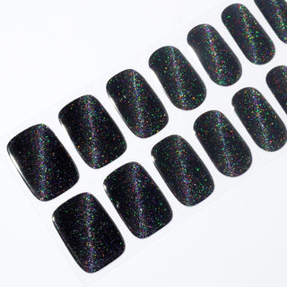 Angled image of semi-cured gel nail stickers in the design 'Meow Me Back,' featuring a sleek black base with holographic glitter for a bold and dazzling look.