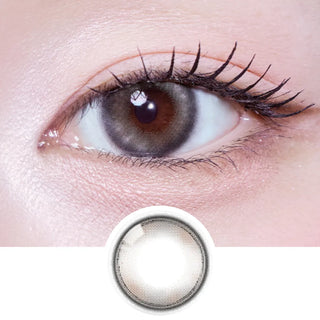 Close-up of eye with long lashes wearing EyeCandys Olola Meow Koshort Grey prescription colored contact lens, with lens design shown below.