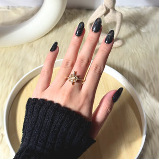 Hand with EyeCandys Meow Me Back Gel nail stickers applied, featuring a sleek black color with glitter accents. Perfect for edgy, glamorous manicures, offering long-lasting wear, easy application, and a sparkling, salon-quality gel finish for eye-catching nails.