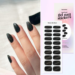 Hand with EyeCandys Meow Me Back Gel nail stickers applied, featuring a sleek black color with glitter accents. Perfect for edgy, glamorous manicures, offering long-lasting wear, easy application, and a sparkling, salon-quality gel finish for eye-catching nails.