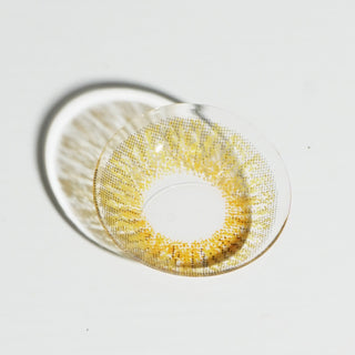 High quality macro shot flatlay of EyeCandys Pink Label New York Brown Contact lens in a plain white backdrop showing the details of the lens