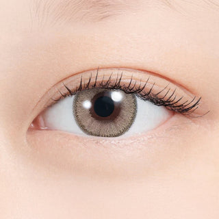 Close-up of eye wearing EyeCandys N's Collection Tempura Beige (10pk) prescription colored contact lens, warm beige brown iris with soft two-tone gradient and natural finish, Korean daily disposable contact lens for subtle everyday eye enhancement