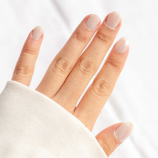 Model's hand showcasing EyeCandys Nudist Gel Nail Stickers. These nude-colored stickers offer a natural, elegant look with a long-lasting, chip-free finish, perfect for effortless and stylish manicures