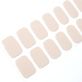 Angled image of semi-cured gel nail stickers in the design 'Nudist,' featuring a chic and minimalist nude beige color for a sophisticated look