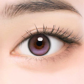 Close-up of model's eye wearing EyeCandys ONE PICK Balance Lavender Mist prescription contact lens, featuring a soft lavender tint that enhances eye color with a natural, vibrant look, providing clear vision and comfort