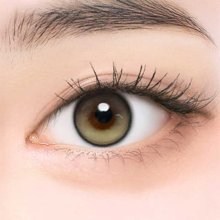 Close-up of model's eye wearing EyeCandys ONE PICK Balance Olive Breeze prescription contact lens, featuring a subtle olive tint that enhances eye color with a natural, vibrant look, offering clear vision and all-day comfort