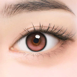 Close-up of model's eye wearing EyeCandys ONE PICK Balance Peach Bloom prescription contact lens, featuring a soft peach tint that enhances eye color with a natural, radiant look, providing clear vision and all-day comfort