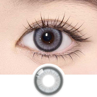 Olala Meow Burman Grey color contact lens on top of a dark eye paired with subtle eye makeup and curled wispy eyelashes, above the contact lens design.