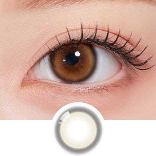 Olala Glee Brown color contact lens on top of a dark eye paired with subtle peach eyeshadow and curled wispy eyelashes, above the contact lens design.