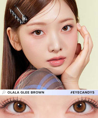 A female model with natural dark eyes wearing Olala Glee Brown contact lenses, complemented by subtle eyeshadow and peach lipstick and Close-up image showcases the model's eyes adorned with the same Brown contact lenses