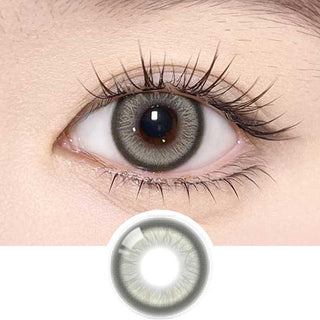 Olala Meow Rubl Green color contact lens on top of a dark eye paired with subtle eye makeup and curled wispy eyelashes, above the contact lens design.
