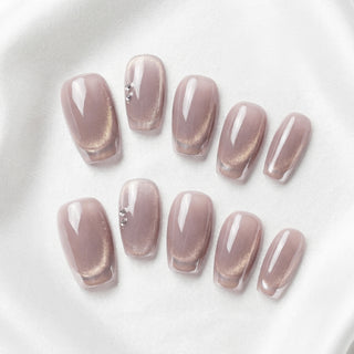 Short coffin press on nails Soft Spoken with ballet pink cat eye effect, chrome iridescent French tips, and minimal diamante detail for a clean luxury finish.
