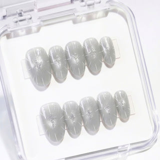 Short almond press on nails Cygnus with icy grey cat eye effect, sharp silver metallic details, and structured minimalist nail design for a modern elegant look.