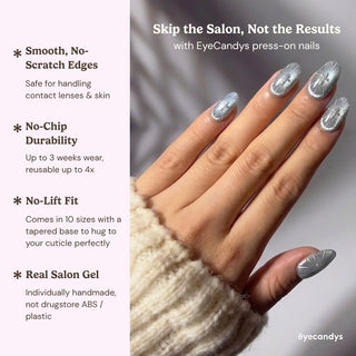 Close up hand showcasing Cygnus press on nails with icy grey cat eye shimmer, silver chrome accents, and minimalist structured nail art design.