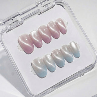 Oval press on nails Eyecandys First Light with seamless blush pink, iridescent gold shimmer, and baby blue gradient for a soft aurora effect.