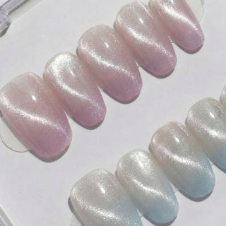 First Light press on nails by EyeCandys featuring blush pink to gold shimmer and baby blue gradient in an aurora inspired oval nail set.